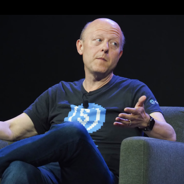 A man wearing a dark blue t-shirt with the text "751" sits in a gray chair, gesturing with his hands as he speaks.

The image shows Jeremy Allaire, CEO of Circle, during what appears to be a panel discussion or interview, visually contextualizing his critical remarks about consortium stablecoins like $OUSD and his defense of $USDC's market dominance.