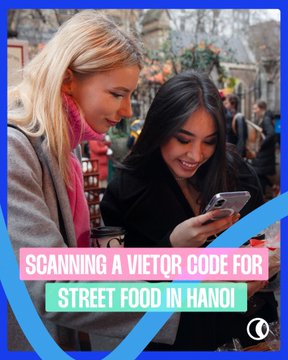 A promotional thumbnail showing two women smiling while looking at a smartphone on a street, with overlay text reading 'SCANNING A VIETOR CODE FOR STREET FOOD IN HANOI'.