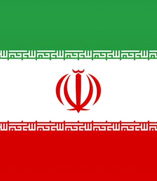The image displays the flag of Iran, featuring horizontal green, white, and red stripes with the red national emblem centered on the white band and Kufic script along the borders of the stripes. The flag represents Iran in the context of the post discussing the Iranian rial's collapse to an all-time low against the US dollar.