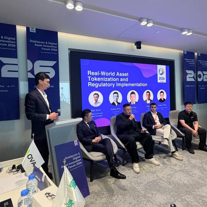 A panel discussion on "Real-World Asset Tokenization and Regulatory Implementation" at the Stablecoin & Digital Asset Innovation Forum 2026 in Abu Dhabi, hosted by Alex Scott (afscott), featuring four seated panelists including Bobby Zhou, Robin Du, Nakul, and Jingyao Yang, with one speaker standing at a podium holding a microphone.