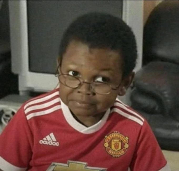 A young boy wearing a red Manchester United jersey and glasses looks off to the side with a side-eye expression. The post references "X payout," and the image humorously conveys skepticism or scrutiny about cashing out, matching the skeptical side-eye expression as if to say "are you sure about that?"