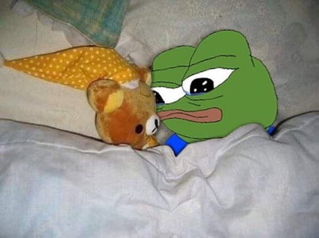 A meme image featuring a Pepe the Frog character next to a small teddy bear tucked into a bed with white sheets.