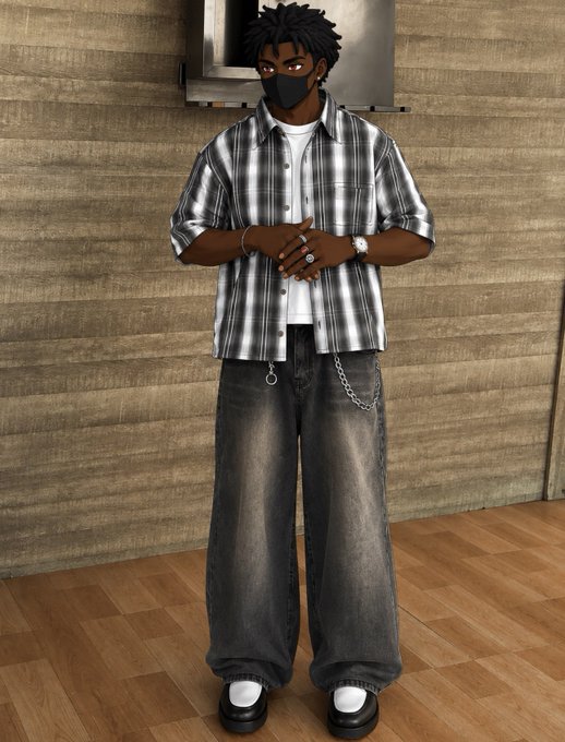 A person wearing a black face mask, a black and white plaid shirt, baggy dark jeans with a chain, and black platform shoes stands against a wooden wall.