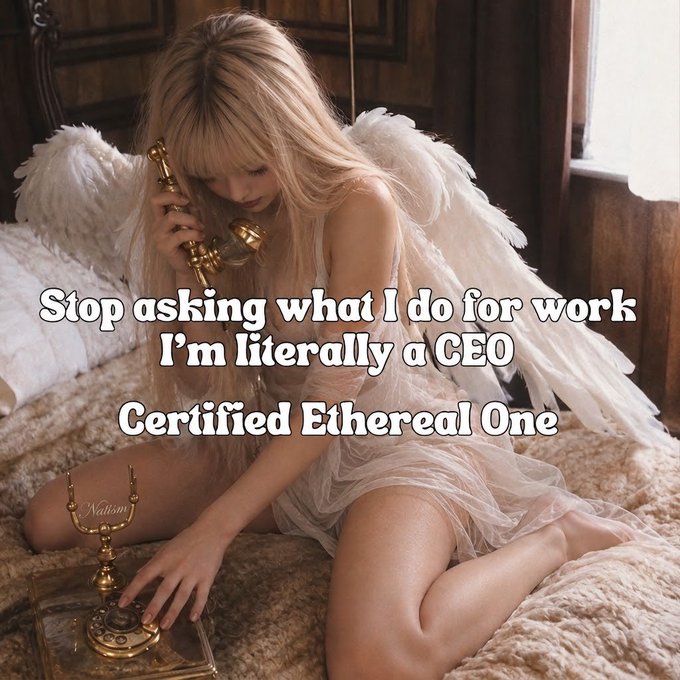 A young woman with long blonde hair, dressed in a sheer white tulle dress and white feathered angel wings, kneels on a fluffy white bed while holding an ornate vintage gold telephone to her ear and resting her hand on its base. Overlaid text reads: "Stop asking what I do for work I'm literally a CEO Certified Ethereal One," with a small watermark "Nailuni" visible near the candlestick, playfully tying the angelic aesthetic to the self-proclaimed title.