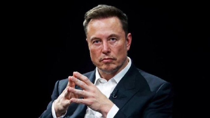 A serious-looking Elon Musk gestures with his hands clasped together while wearing a dark suit against a black background. The image accompanies a misleading post claiming SpaceX is joining the NASDAQ-100 index and that this will trigger massive Bitcoin inflows, though Musk's expression and the lack of any verifiable on-screen text, logos, or exchange data make the claim visually unverified.