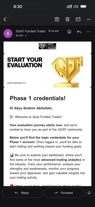 A screenshot of an email from GOAT Funded Trader at 8:14 AM welcoming "Aliyu Ibrahim Abdullahi" with Phase 1 evaluation login credentials, featuring a gold "START YOUR EVALUATION" trophy graphic, which corresponds to the poster's announcement of starting a new $100,000 GOAT Funded Trader challenge.