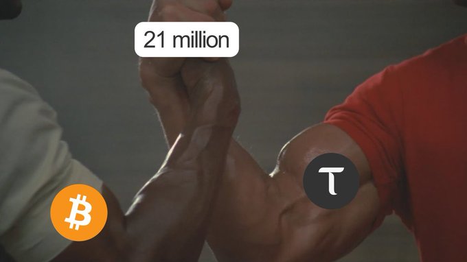 Two muscular arms engage in an arm-wrestling match between a Bitcoin (BTC) logo and a Bittensor (TAO) logo, with a "21 million" label above—referencing Bitcoin's maximum supply cap while drawing a humorous parallel to Bittensor's competitive stance.