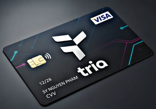 A black credit card with a colorful tech-inspired design displays the brand name 'tria', a Visa logo, and the cardholder name 'SY NGUYEN PHAM'.