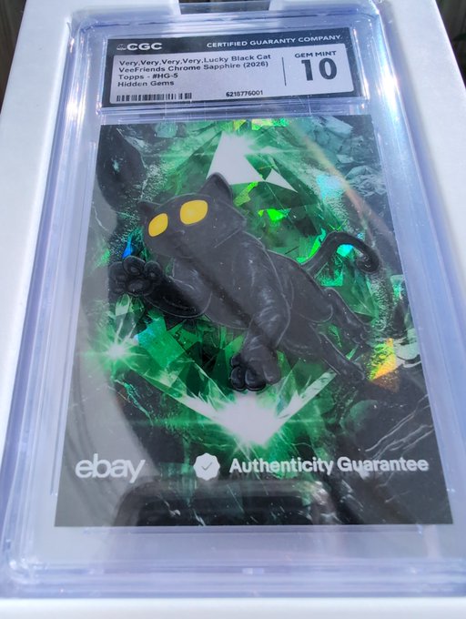 A graded CGC Gem Mint 10 trading card featuring Topps Chrome Sapphire 'Hidden Gems' artwork of a black cat with glowing yellow eyes set against a holographic green geometric background, marked with an eBay Authenticity Guarantee sticker.