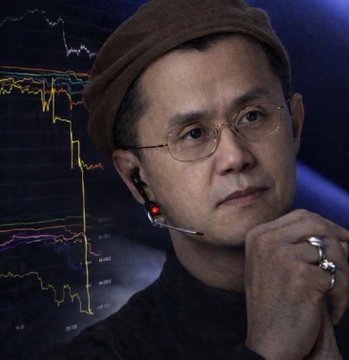 In the image, there's a man wearing glasses and a hat who appears to be thinking about something. The background of the photo shows a graph with stock price fluctuations over time. This suggests that the man might be interested in analyzing market trends or making financial decisions based on the data presented in the graph. It could also indicate his expertise in the stock market, as he seems confident and focused while studying the patterns displayed on the screen. The post about him buying and selling cryptocurrencies for millions of dollars emphasizes this focus on analyzing markets and potentially capitalizing on their fluctuations to earn substantial profits.
