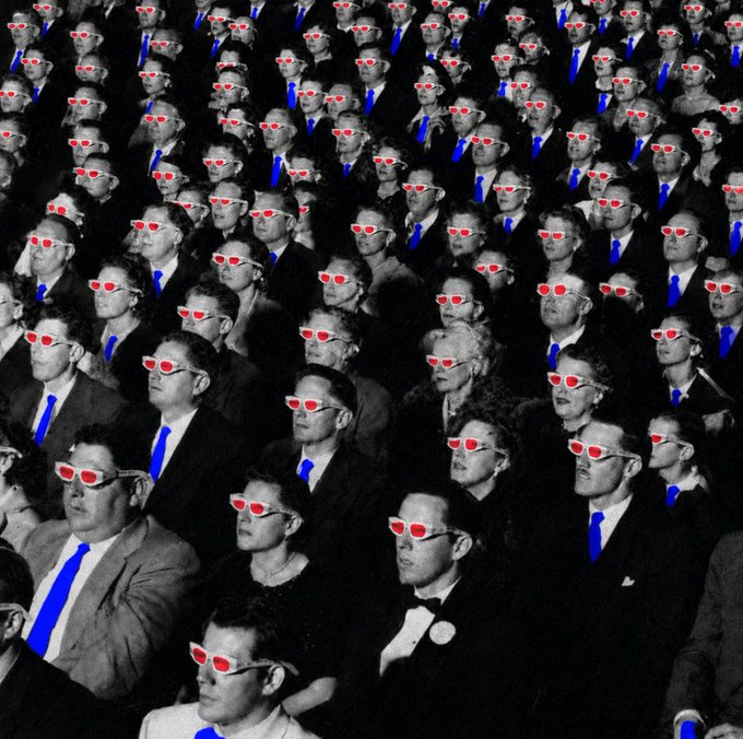 The image portrays a crowded room filled with people wearing ties and sunglasses, appearing as if they're watching something together or taking part in an event. Some of them are wearing red glasses that add a pop of color to their outfits. The photo is labeled "All eyes on the charts". This could be interpreted as the gathering of individuals, possibly attending a conference or a meeting where everyone's attention has been drawn to a particular presentation or discussion.