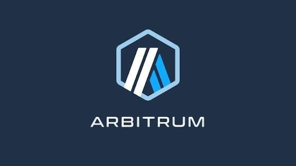 The Arbitrum logo, featuring a hexagonal emblem with blue and white angular lines, is displayed on a dark blue background.
