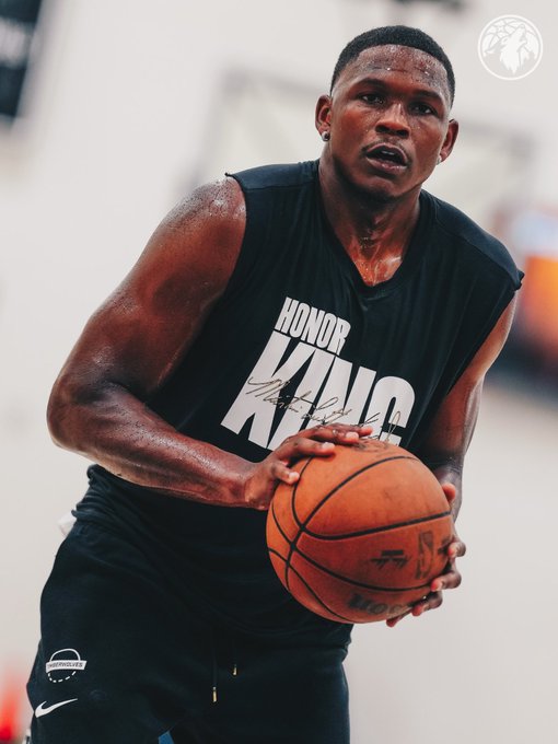 A focused basketball player in a black "HONOR KING" jersey holds a basketball at the ready, with the post's "WE HAVE ANOTHER CLONE" caption suggesting he shares a striking resemblance to another well-known athlete or figure.
