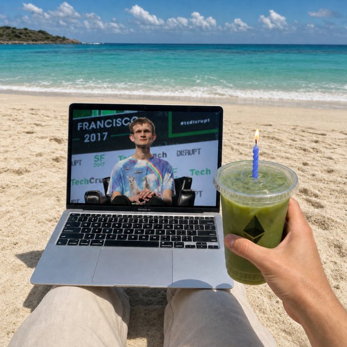 A first-person view from a beach showing a MacBook displaying a 'Francisco 2017' TechCrunch event with a man in a tie-dye shirt, while holding a green drink with a lit blue candle in the other hand.