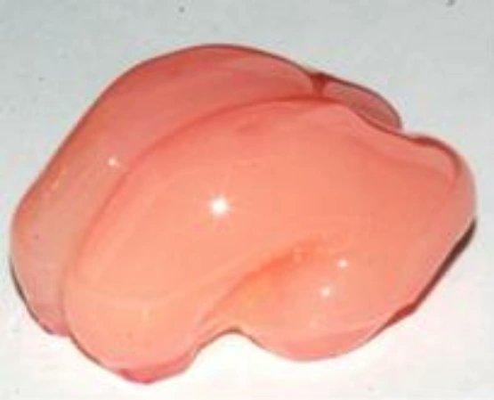 A glossy pink heart-shaped object rests on a light surface, its smooth, gel-like appearance giving it a soft, fleshy quality. The image's romantic heart imagery pairs with the post's suggestive undertone, evoking a playful sense of intimacy amid the casual tech-related caption.