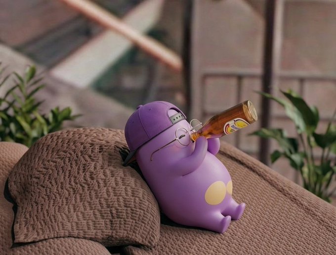 A purple cartoon character figurine wearing glasses and reclining on a textured pillow while drinking from a bottle.