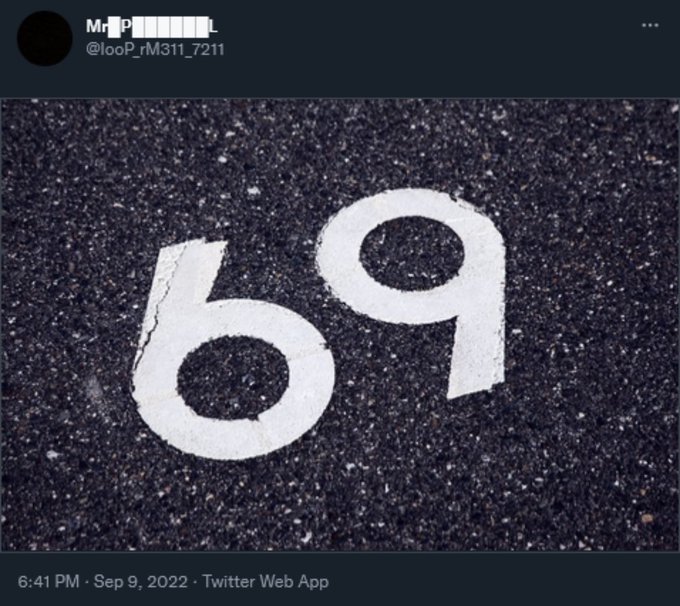 A tweet showing a close-up photo of the number '69' painted in white on dark asphalt.