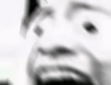 A blurry, low-resolution black-and-white close-up of a distorted face, likely a meme expressing shock or horror, paired with a story about someone having their phone stolen, losing funds ("170wu"), and being impersonated via face cloning. The unsettling, pixelated image visually amplifies the victim's disbelief and distress at the elaborate identity theft and theft they experienced over two days without noticing.