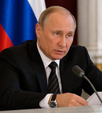 This image shows Vladimir Putin, who has signed Russia's first comprehensive crypto law, while the US Senate has yet to vote on the CLARITY Act. The juxtaposition highlights contrasting legislative progress on digital assets between the two nations.
