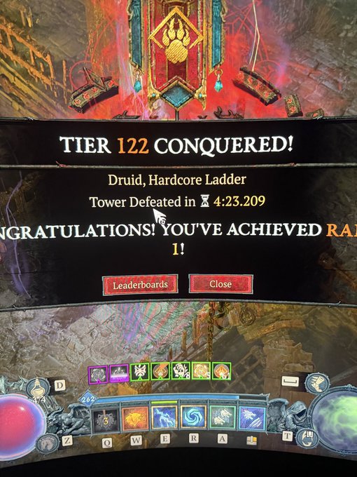 Diablo IV gameplay screenshot showing a victory screen that reads "TIER 122 CONQUERED! Druid, Hardcore Ladder, Tower Defeated in 4:23.209" with skill bars visible at the bottom.