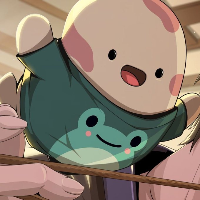 A chibi-style white bear character with pink markings wears a teal shirt featuring a smiling frog design. The cute illustration fits the cheerful "GM Legends Happy Beanz Day" greeting, embodying the wholesome, community spirit of the post.