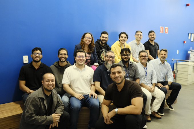 A group of about 13 educators and researchers pose together at SENAI CIMATEC in Salvador, Brazil, following a three-day Cardano development workshop. The post describes the visit as part of an effort to train Brazil's next generation of technologists on blockchain development, applications, and use cases.