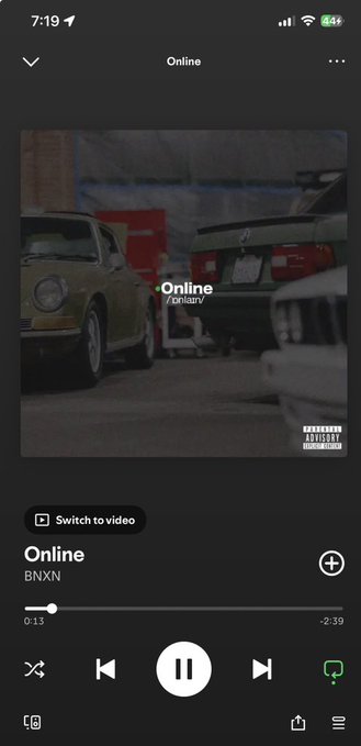 A Spotify mobile screenshot playing the song "Online" by BNXN with an album cover showing vintage cars in a garage and a Parental Advisory label.
