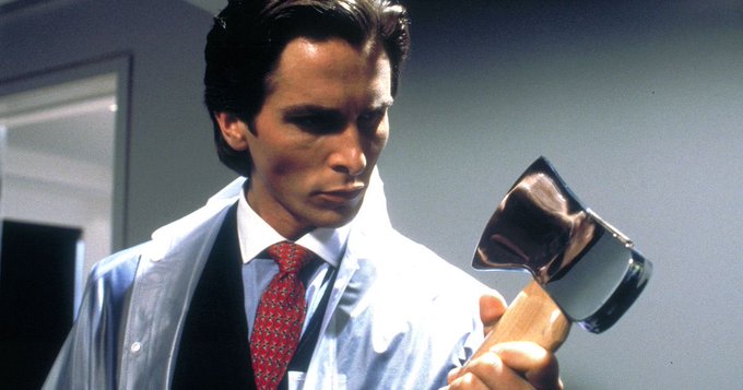 A scene from the film American Psycho showing Patrick Bateman (Christian Bale) in a clear raincoat examining a meat cleaver.