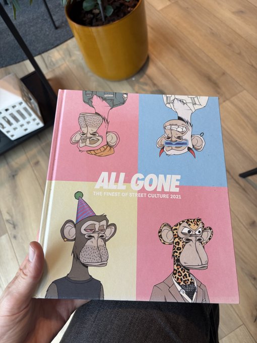 A person holds the book 'ALL GONE: THE FINEST OF STREET CULTURE 2021' featuring four illustrated monkey characters in colorful outfits on the cover.