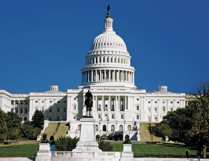 The image shows the U.S. Capitol Building under a clear blue sky, with the iconic Statue of Freedom atop its dome. The accompanying post about the House holding a hearing on the Crypto CLARITY Act connects to this setting, as the Capitol serves as the seat of the legislative branch where such crypto legislation hearings would take place.