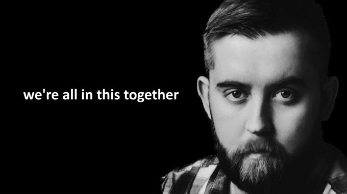 A black and white portrait of a bearded man with the text 'we're all in this together' displayed on the left side.