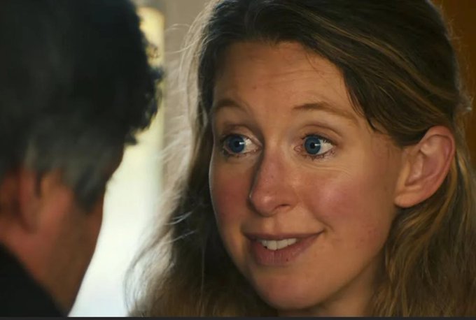 A close-up shot of a woman with brown hair and bright blue eyes smiling at a man whose silhouette is visible in the foreground, appearing to be a scene from a film.