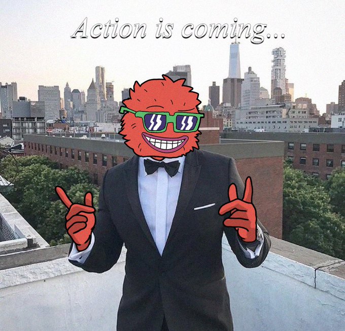 The image shows a man in a tuxedo with red hands, a cartoon red furry face, and green sunglasses pointing upward, with the text "Action is coming..." above him against a city skyline background. The meme suggests an upcoming wave of influence in the $WOLFI/AVAX space, with @ExcelBaller positioned as a key figure ("Ansem") of the AVAX community ready to drive action.