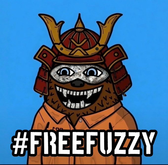 A cartoon bear mascot wearing samurai armor and a prison jumpsuit is displayed against a blue background with the hashtag "#FREEFUZZY" prominently shown, illustrating the suspended Twitter/X account @fuzzy_xrp that the post claims was unjustly banned on July 22nd despite following no rules.