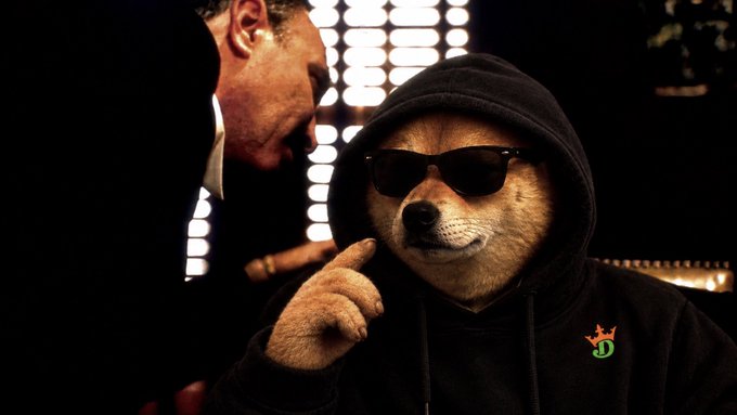A man in a suit leans in toward a Shiba Inu dog wearing sunglasses and a black hoodie, posing his paw against his chin in a thoughtful gesture. The dog's hoodie features a small "DJ" logo with a crown, matching the post's reference to meme coins like WIF, BONK, POPCAT, and FARTCOIN, with the dog representing the meme coin culture of crypto mascots.