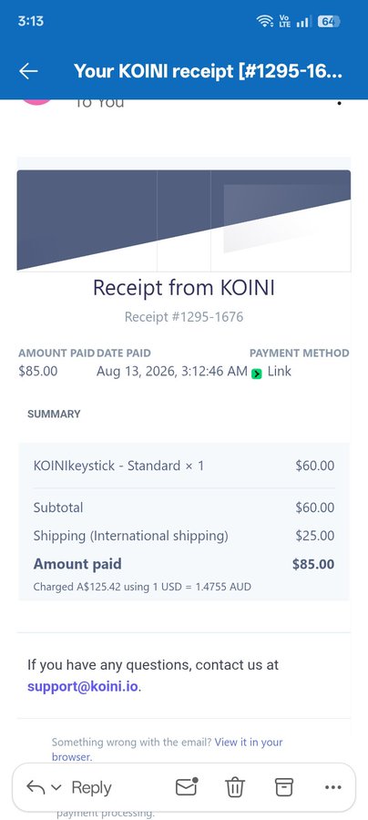 A smartphone screenshot of an email receipt from KOINI for a KOINIKeystick - Standard priced at $60.00 plus $25.00 international shipping, totaling $85.00 paid via Link on Aug 13, 2026.