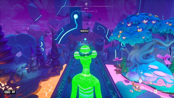 A first-person view of a colorful, stylized 3D video game world with a green, plant-like character (labeled 'NIKOVI') navigating a path between a fiery, jagged landscape and a lush, glowing blue tree area, with a mini-map and the text 'Temple Garden' visible.