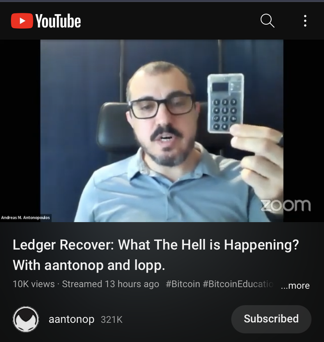 A YouTube thumbnail shows Andreas M. Antonopoulos in a Zoom call holding a small numeric keypad device, with the video titled "Ledger Recover: What The Hell is Happening? With aantonop and lopp," which has 10K views, 321K subscriber channel, and hashtags #Bitcoin #BitcoinEducation. The image relates to the post by visually representing Antonopoulos, the "hero" referenced, now discussing the Ledger device he once recommended, reinforcing the message about not blindly trusting trusted figures and instead verifying claims—especially relevant given the Ledger Recover controversy.