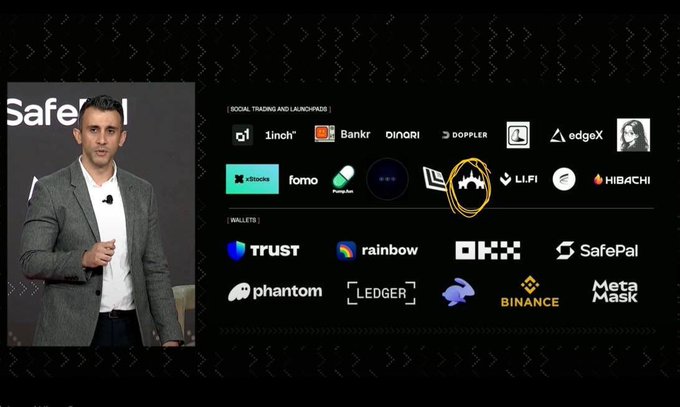 A man stands presenting at the "Safe" event beside a slide showcasing Arc's mainnet partners, with logos for social trading/launchpads like 1inch, Bankr, Pump.fun, FOMO, and wallets including Trust, Rainbow, Phantom, Ledger, and SafePal. The orange circled Phoenix logo is highlighted as the only trading terminal and launchpad built on Arc, corresponding to the $TOLLY project by TollyLabs mentioned in the post.