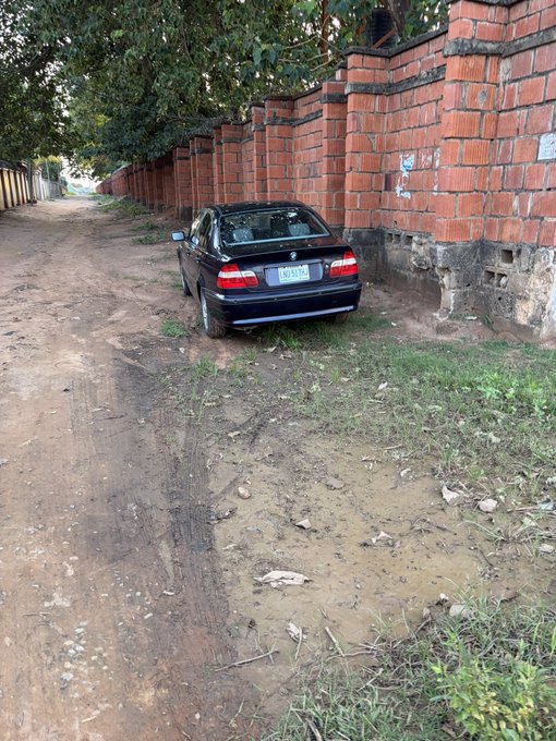 The image features a black car parked on a dirt road, with a brick wall nearby. There are also some rocks scattered around the area. The text "probably my next buy" suggests that the person who posted this photo might be considering purchasing the car or is excited about it in some way.
