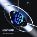 A sleek promotional graphic featuring a stylized metallic "REAL TOKEN" logo alongside the Biconomy exchange logo, with the caption "REALTOKEN - Changing the World One Token at a Time," visually announcing the official listing of REAL Token (built on the XRP Ledger) on the Biconomy Exchange.