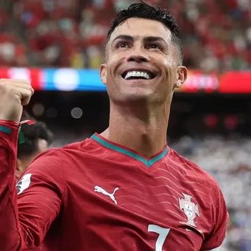 Cristiano Ronaldo, wearing Portugal's red Puma jersey with the number 7, smiles broadly and raises a clenched fist in celebration, reflecting his commitment to lead his national team at his final FIFA World Cup in 2026.