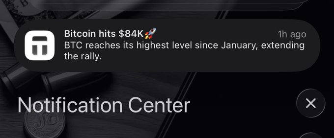 An iOS Notification Center screen displaying an alert that reads 'Bitcoin hits $84K 🚀 - BTC reaches its highest level since January, ending the rally.'