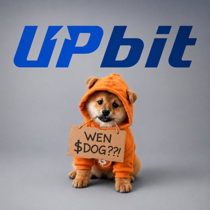 An advertisement for UPbit featuring a Shiba Inu dog in an orange hoodie holding a cardboard sign that reads "WEN $DOG??!"