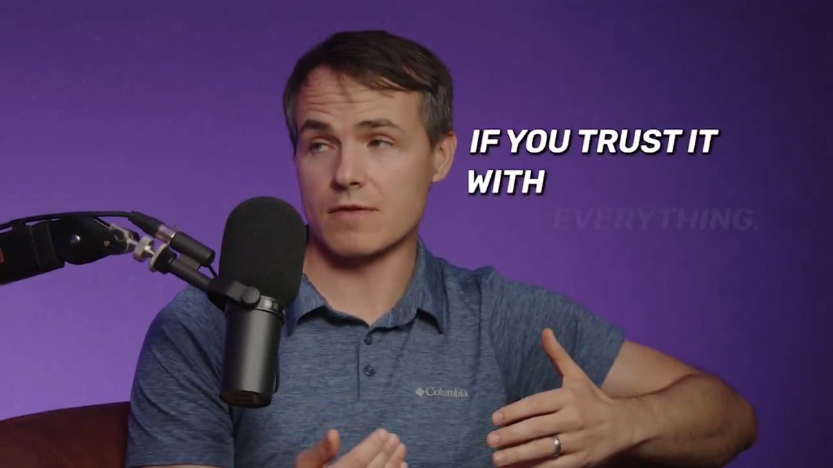 A man in a blue Columbia polo shirt speaks into a podcast microphone against a purple background, with the text "IF YOU TRUST IT WITH" overlaid and "EVERYTHING" faintly visible behind him.