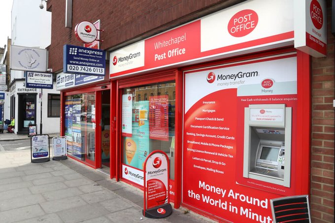 The image shows the Whitechapel Post Office with a prominent red MoneyGram storefront, advertising money transfer services with the slogan "Money Around the World in Minutes" and listing services including cash withdrawals and balance enquiries. This visual supports the post's announcement about Credible integrating cash-in/cash-out capabilities through MoneyGram terminals as part of their Open Payment Stack initiative.