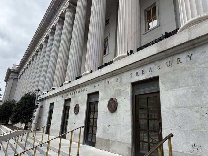An exterior photo of a grand neoclassical government building featuring large columns and the engraved text 'THE DEPARTMENT OF THE TREASURY' above the entrance doors.
