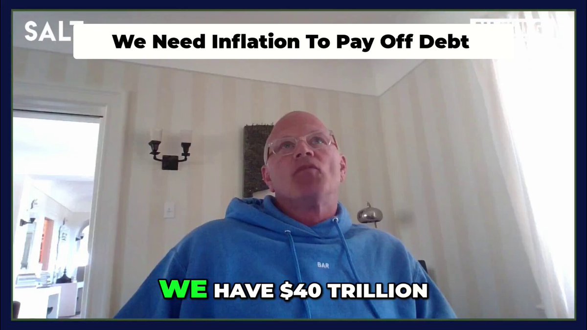The image features a man wearing glasses sitting next to a television screen that displays some text. A caption below the video shows the word "SAL" at the top left corner of the picture, which seems to be related to the content on the screen. The title of the video is written above the man's head in green, and it reads: "WE NEED INFLATION TO PAY OFF DEBT. WE HAVE $40 TRILLION".