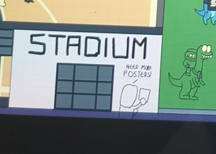A cartoon image of a building labeled "STADIUM" with a note saying "NEED MORE POSTERS!" and a stick figure pointing at it, with a green dinosaur mascot nearby.