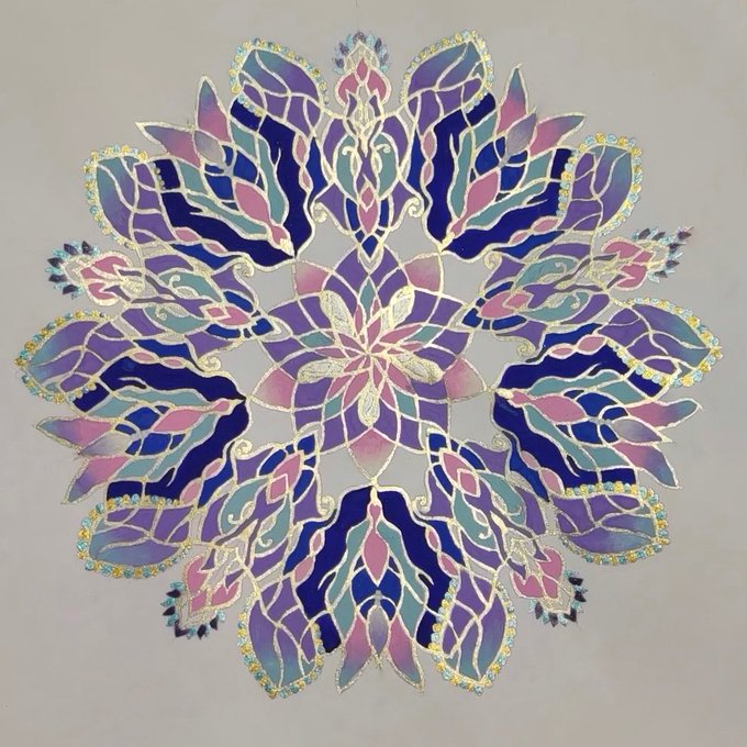 Intricate geometric mandala artwork featuring leaf-like petals in shades of blue, purple, pink, and teal with gold accents on a cream background.